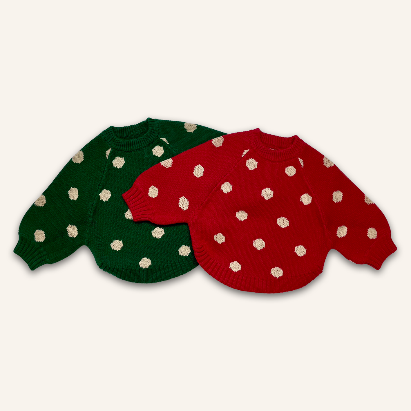 2 baby toddler jumpers laid flat in green and red knit