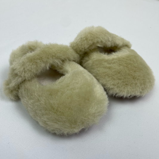 Green fluffy baby slippers front angle view